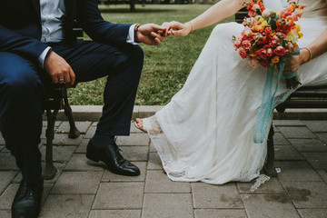 bride and groom in white dress with bouquet of flowers