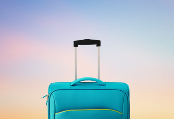 holidays. travel concept. blue suitcase infront of bokeh background