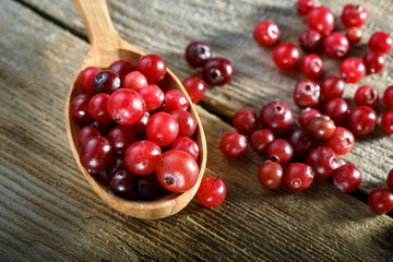 Cranberries in a wooden spoon.