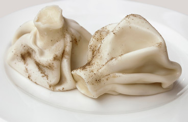 Hot delicious khinkali with black pepper, Georgian national dish.