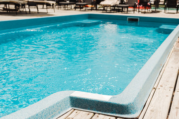 Fototapeta na wymiar swimming pool with clean blue water in beach club outdoors