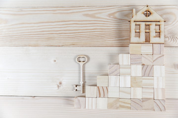 Naklejka na ściany i meble Real estate concept. Small toy wooden house with keys