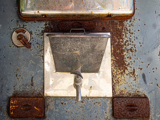 A water heater faucet on an old Finnish wood stove