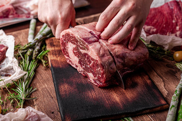 Fresh Raw Beef Steak Ribeye, with salt, peppercorns, rosemary, tomatoes , asparagus and olive oil