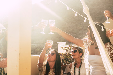 Happy and cheerful group of people females young friends together cheering and toasting celebrating...