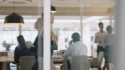 beautiful business woman using smartphone walking through office texting sending emails successful female executive checking messages on mobile phone arriving at busy workplace 4k   - Powered by Adobe