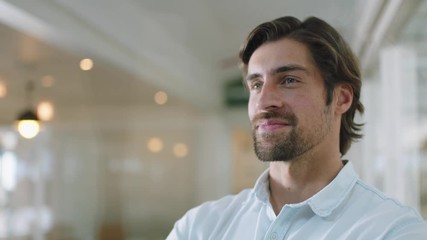 portrait successful businessman smiling confident with arms crossed enjoying corporate leadership young male executive planning ahead for positive future in office 4k footage