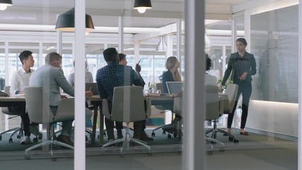 group of business people meeting in boardroom team leader woman presenting ideas on whiteboard discussing strategy with colleagues in office training presentation 4k - Powered by Adobe