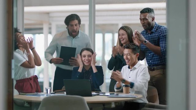 group of business people celebrating success watching laptop screen happy colleagues applause enjoying successful corporate victory achievement in modern office 4k