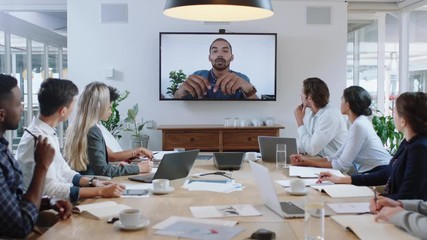group of business people having conference call meeting in boardroom team leader man chatting to colleagues using online video chat on tv screen discussing ideas in office 4k - Powered by Adobe