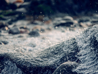 Water motion in a creek abstract background. Cool tone.