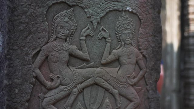 Close view of beautiful bas-relief of apsaras, female spirits of the clouds and waters in Hindu and Buddhist culture. Bayon temple, Angkor Wat complex, Cambodia