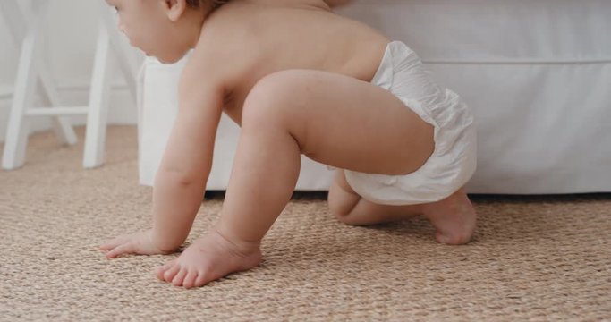 happy baby crawling toddler exploring with curiosity at home with mother gently picking up her infant helping child motherhood responsibility 4k