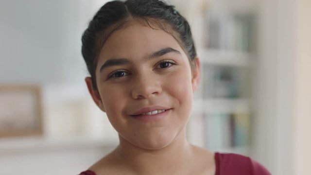 portrait beautiful hispanic girl with smiling happy child looking at camera enjoying childhood happiness at home