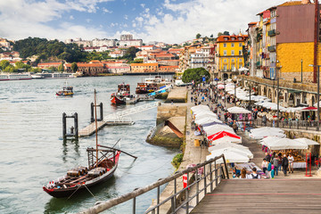 The Douro River with colorful houses and boats of wine in Porto, Portugal.