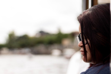 Woman looking forward thoughtful, background blurred