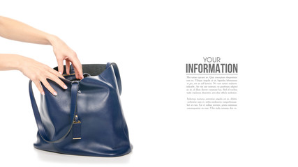 Woman's female blue leather bag in hand, sample text on white background isolation