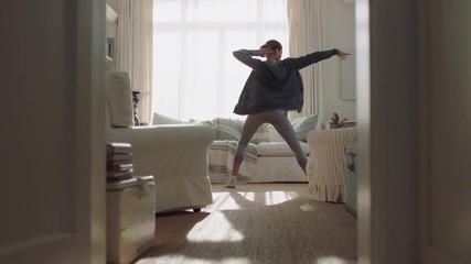 happy young woman dancing at home having fun celebrating with funny dance moves enjoying freedom on weekend morning 4k footage
