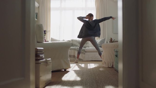 happy young woman dancing at home having fun celebrating with funny dance moves enjoying freedom on weekend morning 4k footage