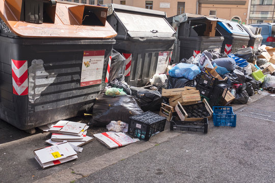 rows of garbage containers with trash and package on the street in Rome in Italy