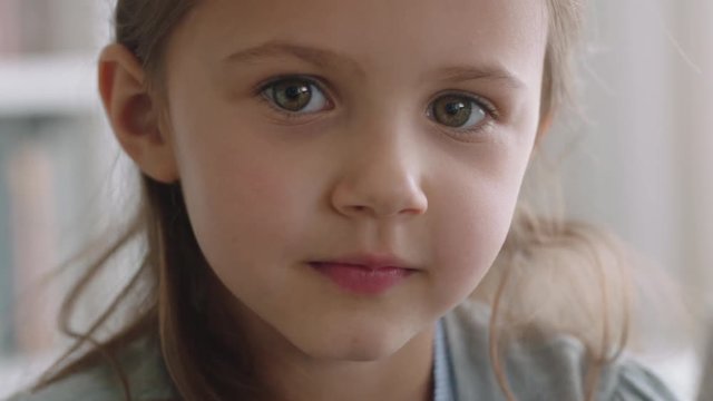portrait beautiful little girl smiling with natural childhood curiosity looking joyful child with innocent playful expression 4k footage