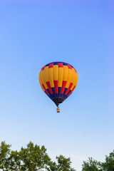 Fototapeta na wymiar Colorful hot air balloon on the background blue sky.