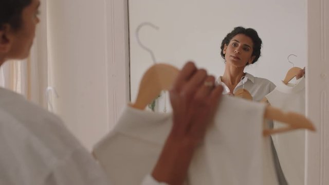 beautiful woman dressing getting ready for work putting on clothes smiling looking in mirror enjoying fresh new day feeling positive 4k footage
