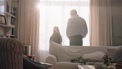 grandfather and child opening curtains curiously looking out window little girl enjoying beautiful new day with grandpa 4k footage