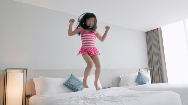 girl jump on the bed