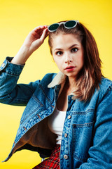 lifestyle people concept: pretty young school teenage girl having fun happy smiling on yellow background close up