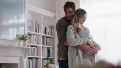 happy pregnant couple dancing together at home husband embracing wife gently holding her belly enjoying intimate dance - Powered by Adobe