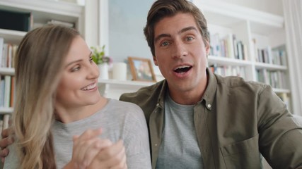 happy couple video chatting using webcam waving at baby smiling excited enjoying online communication at home 4k footage