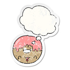 cute cartoon donut and thought bubble as a distressed worn sticker