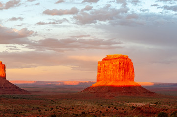 Fototapeta na wymiar The famous Merrick and Mittens Buttes from monument valley basking in the Light of the setting sun.