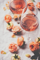 Rose wine and roses on white background
