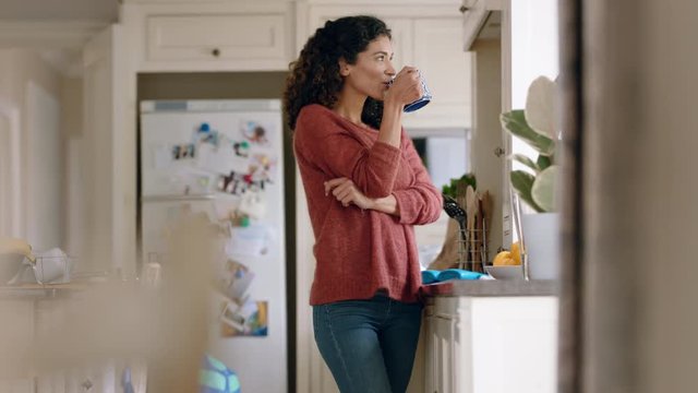 beautiful happy woman drinking coffee at home looking out window thinking of future planning ahead enjoying comfortable lifestyle