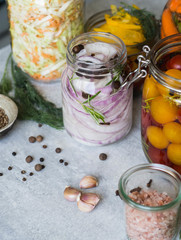 Pickled vegetables. Salting various vegetables in glass jars for long-term storage. Preserves vegetables in glass jars. Variety fermented green vegetables on table. Copy space