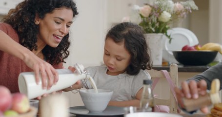 happy family eating waffles for breakfast with children enjoying delicious treat in kitchen at home - Powered by Adobe