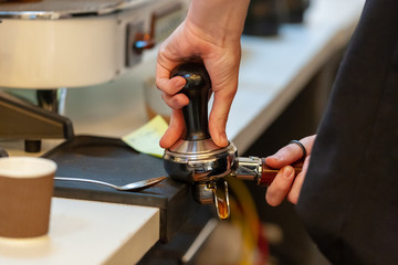 barista making coffee with coffee machine.
