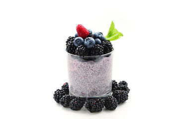 Fototapeta na wymiar Chia pudding with mint, blueberry, blackberry on a white background. Space for text or design.