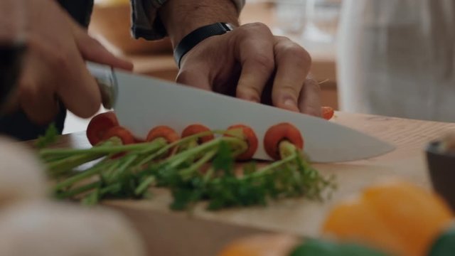 close up hands chopping carrots using knife preparing fresh homemade meal with vegetables for cooking healthy organic lifestyle at home 4k footage