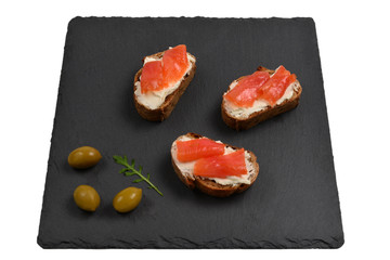 Salmon on a bread with cream isolated on white.