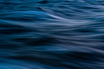 Obraz na płótnie Canvas Gentle soothing silky flowing natural ocean water movement. Abstract background motion blur. Serene and peaceful deep blue sea in nature.