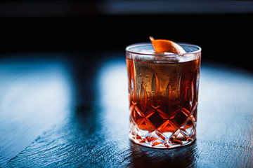 Negroni cocktail on dark stone table. With space for your text