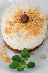 Cream cake with whole and ground hazelnuts