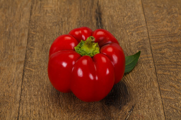 Ripe Red bell pepper over wooden
