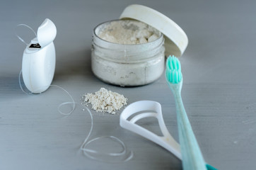 Set of oral care products on gray table.