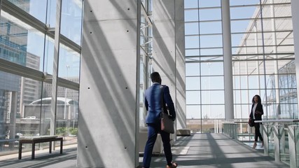 business people shaking hands african american businessman meeting female colleague in corporate office greeting with handshake welcoming client 4k - Powered by Adobe