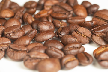 Coffee beans on a white background, closeup. Selective focus