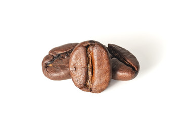 Three roasted coffee beans on a white background